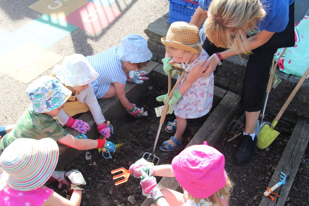 Gardening with Pre-School planting seeds